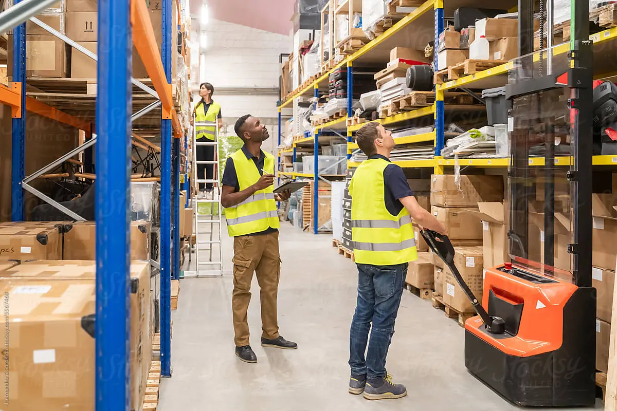 Team reviewing warehouse inventory as part of large-scale product evaluation